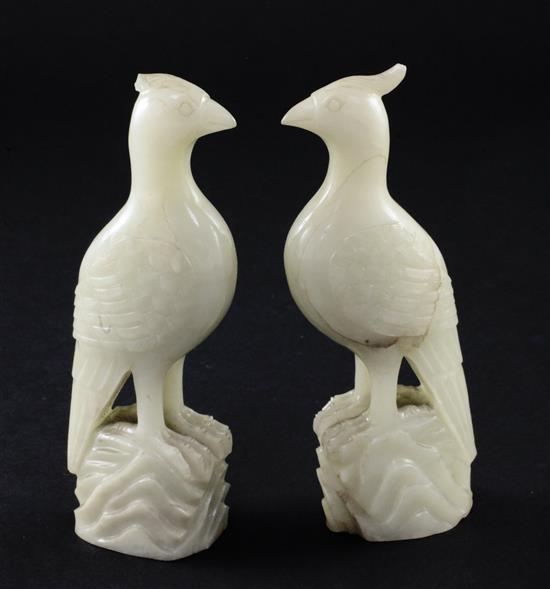A pair of celadon-white jade standing figures of pheasants, 20th century, 4.3cm, chips to crests